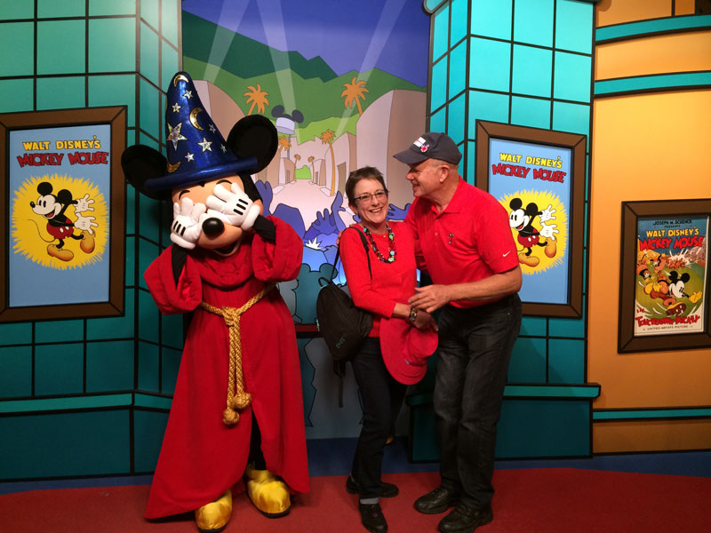 Workampers Geoff & Laura Baker posing with Micky Mouse at Walt Disney World Magic Kingdom