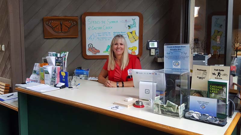 Workamper Volunteer Jane Lewis posing at desk, Caesar Creek Visitor Center and Learning Center, Ohio