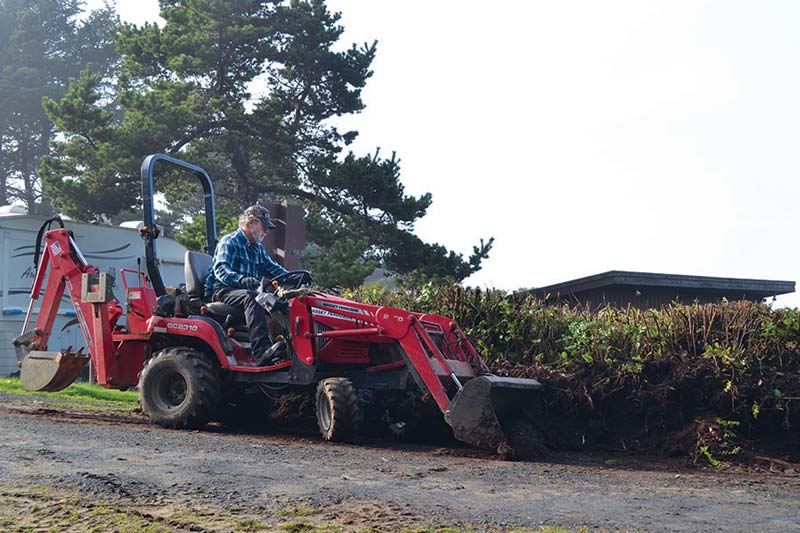 Workamper man on a tractor spreading dirt