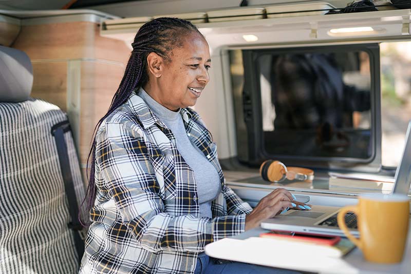 Woman working on her laptop in her RV.