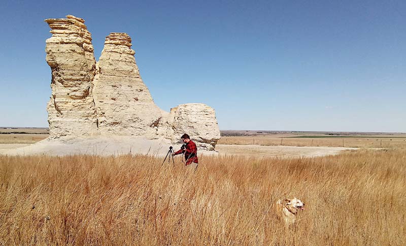 Workamper Levi Henley setting up a tripod at Castle Rock, a historic limestone formation along the Overland Trail in Kansas.