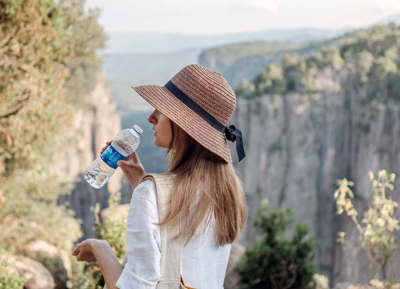 woman at campground drinking water