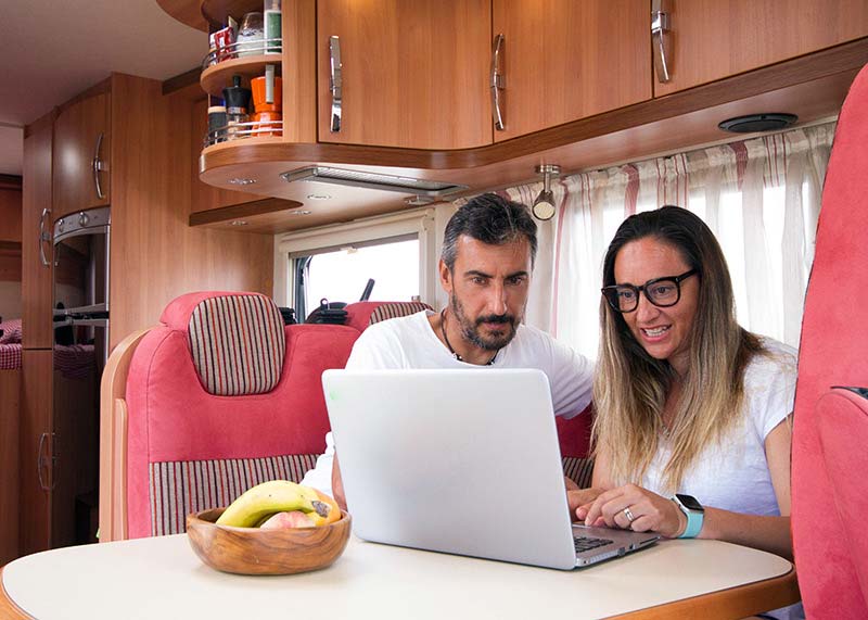 couple on laptop in RV