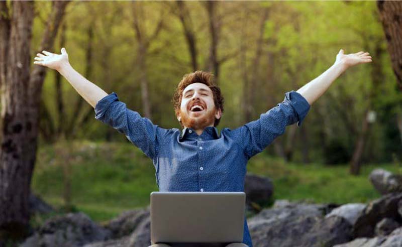 Man Working with Laptop in Nature