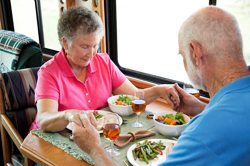 couple praying in an rv