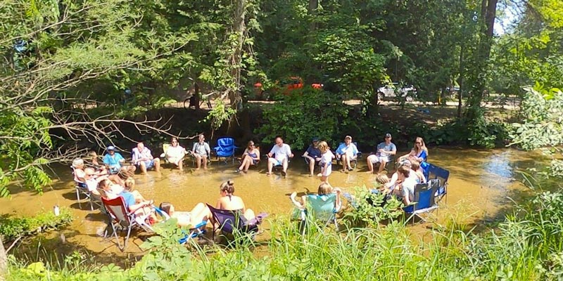 white river rv park guests relaxing in sand creek