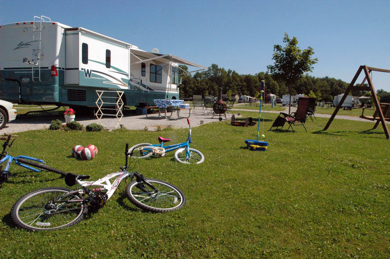 RV campsite cluttered with bikes and toys and equipment