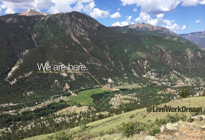 View of a ranch in a valley below mountains
