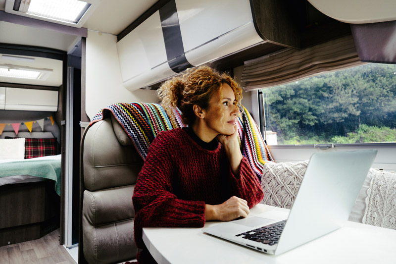 woman working at laptop in rv