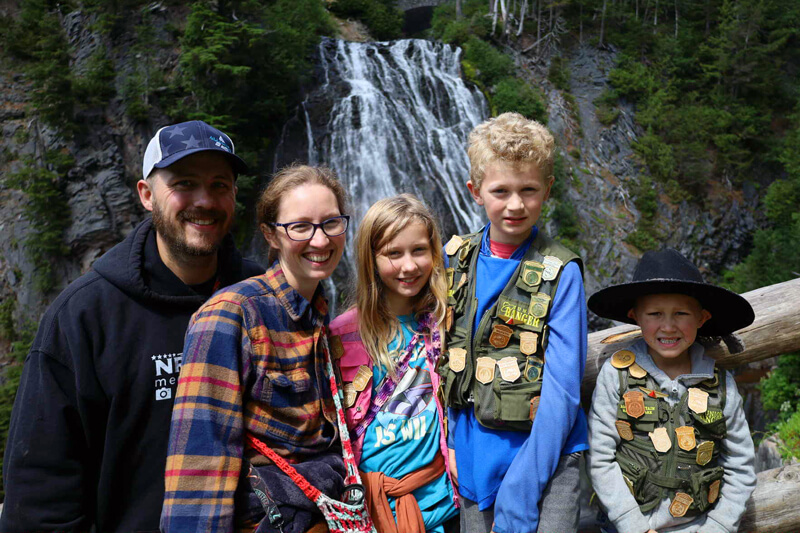 syfrett family standing in front of waterfall