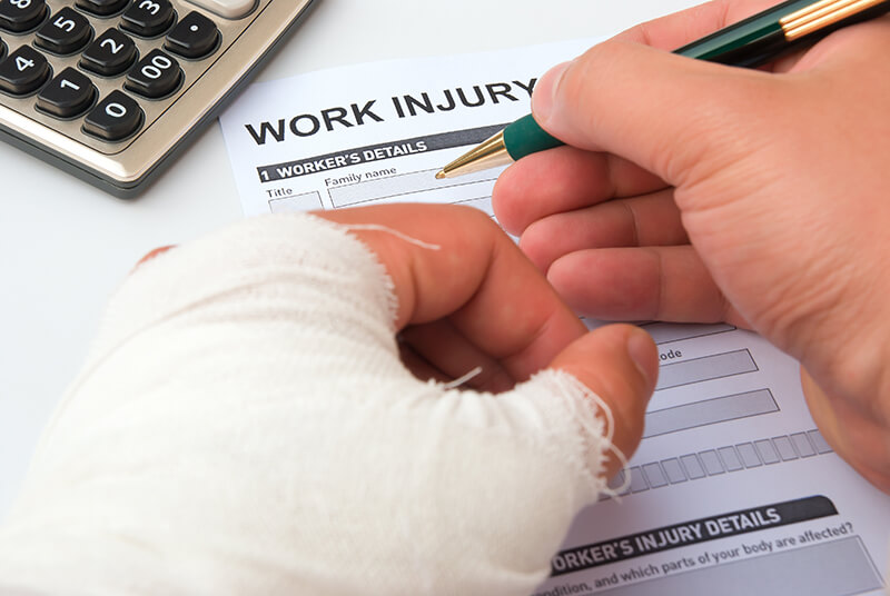 Filling out a work injury form with a hand in a cast
