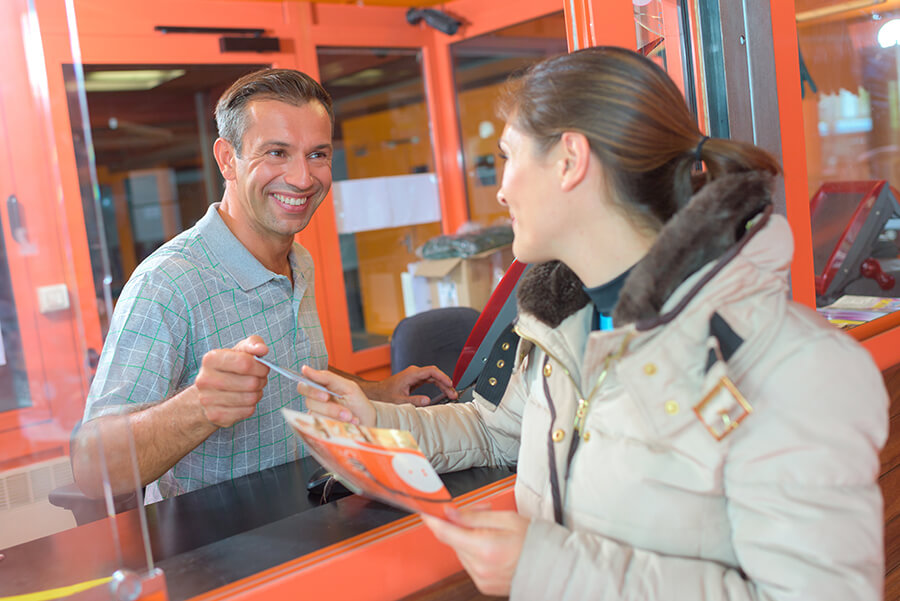 woman buying ticket at booth