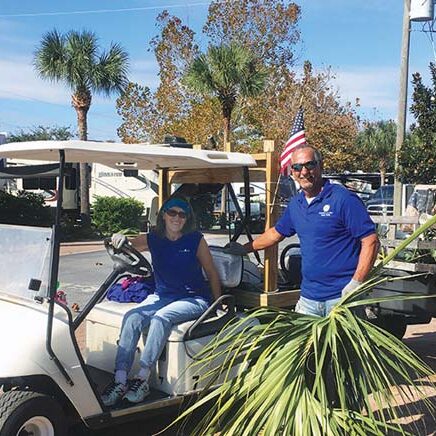 Camp Gulf, Workampers Daniel and Johanne Thibeault landscaping with golf cart.