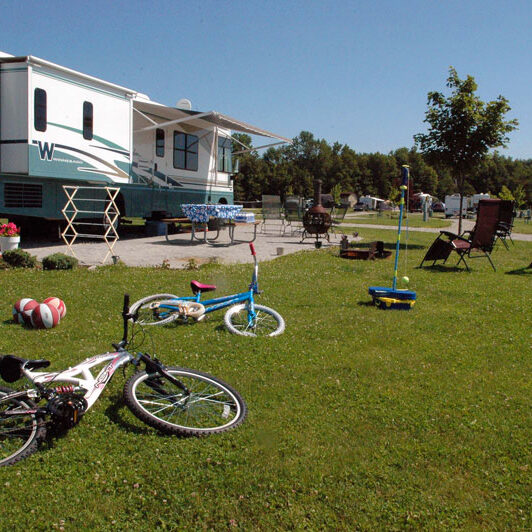 RV campsite cluttered with bikes and toys and equipment