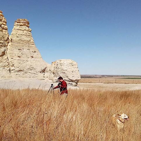 Workamper Levi Henley setting up a tripod at Castle Rock, a historic limestone formation along the Overland Trail in Kansas.