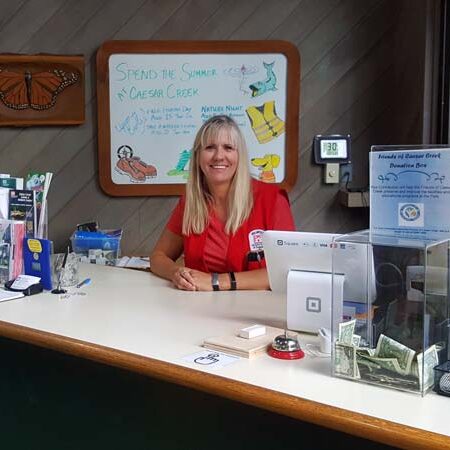 Workamper Volunteer Jane Lewis posing at desk, Caesar Creek Visitor Center and Learning Center, Ohio