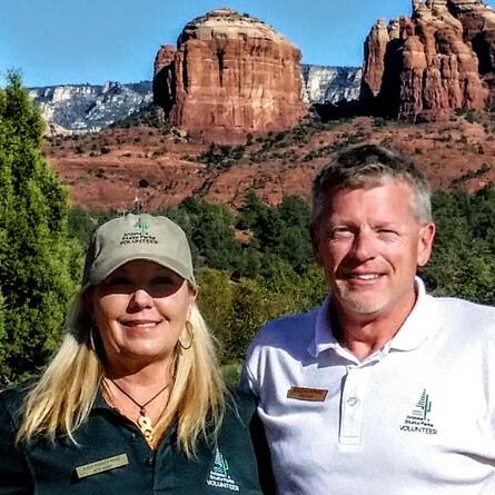Sedona Red Rock Park On-Site Hosts, Workampers Doug & Lisa Kasefang, with red rocks in background.