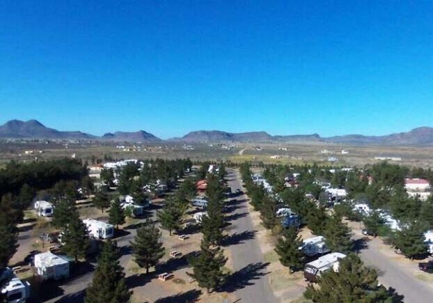 Overhead view of Lost Alaskan RV Park showing organized RV sites and wooded areas, highlighting the campground layout for Workampers.