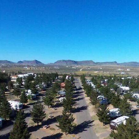 Overhead view of Lost Alaskan RV Park showing organized RV sites and wooded areas, highlighting the campground layout for Workampers.