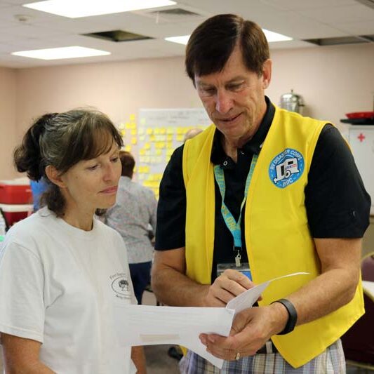 Recreational Vehicle Disaster Corps (RVDC), volunteers look over paperwork.