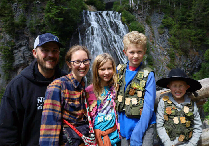 syfrett family standing in front of waterfall
