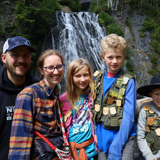 syfrett family standing in front of waterfall