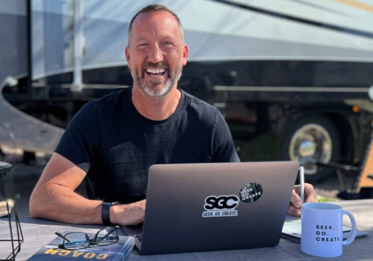 tim winders working on laptop in front of rv