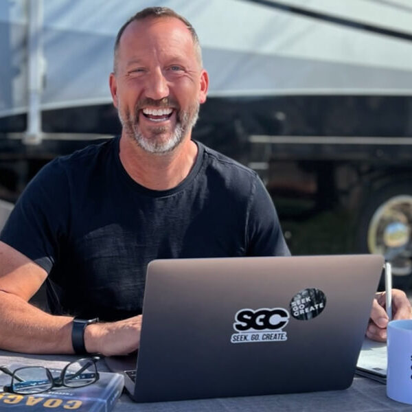 tim winders working on laptop in front of rv