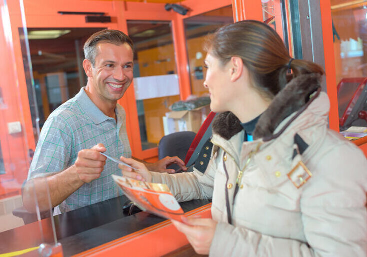 woman buying ticket at booth