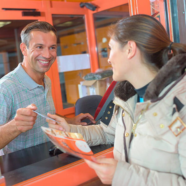 woman buying ticket at booth