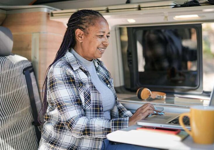 Woman working on her laptop in her RV.