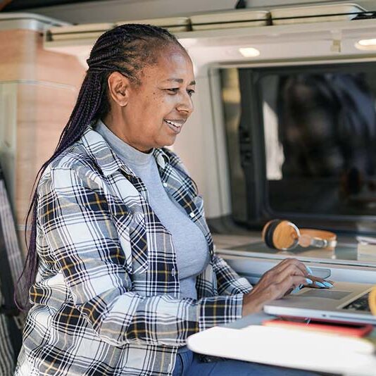Woman working on her laptop in her RV.