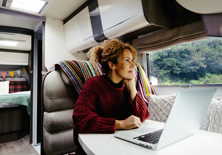 woman working at laptop in rv