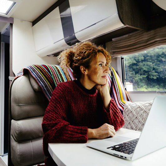 woman working at laptop in rv