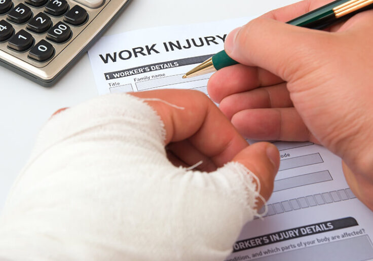 Filling out a work injury form with a hand in a cast