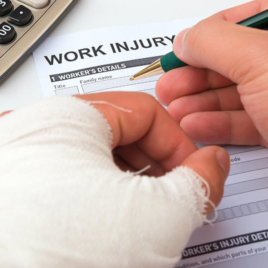 Filling out a work injury form with a hand in a cast