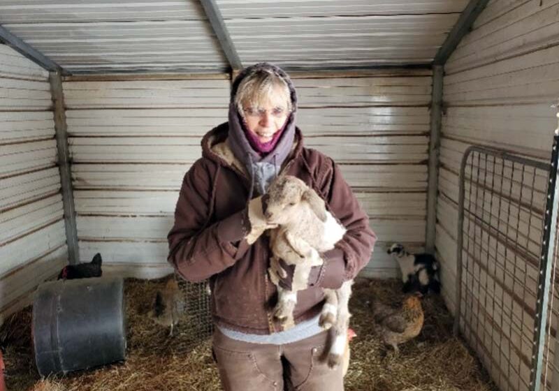 Workamper volunteers stepped up during Texas’ historic 2021 winter storm, woman holding baby goat. at Northeast Texas Community College.